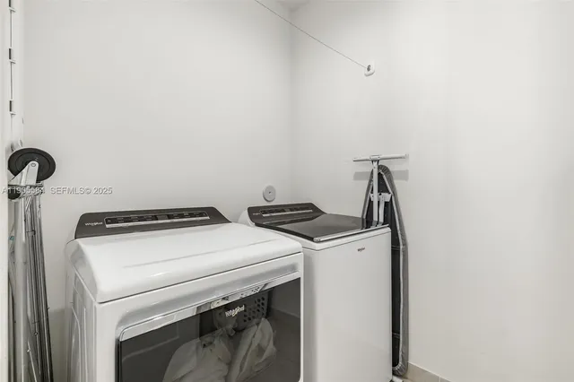 a view of walk in closet with clothes