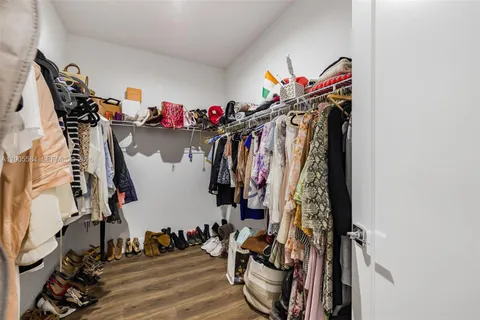 a view of living room filled with furniture and potted plants