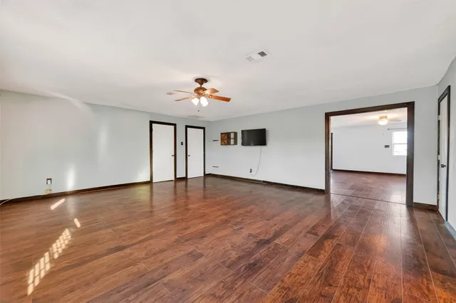 a view of an empty room and wooden floor