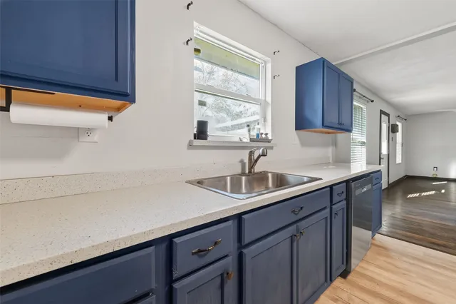 a kitchen with a sink and wooden cabinets