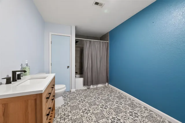 a room that has a bed and a dresser in it