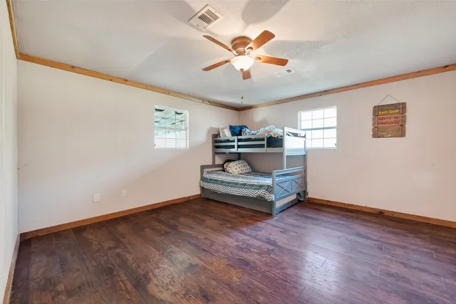 a living room with couch and a ceiling fan
