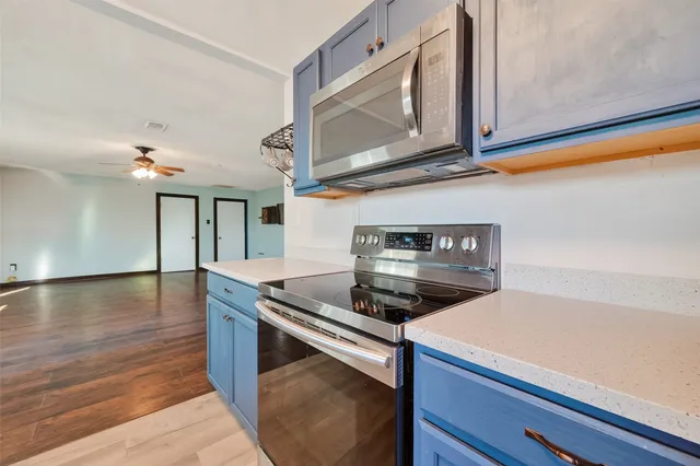 a kitchen with stainless steel appliances granite countertop a stove and a microwave