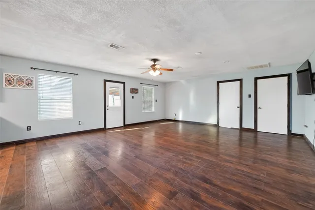 a view of a livingroom with wooden floor and window