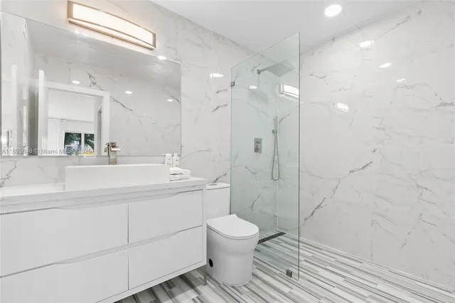 a bathroom with a toilet sink and shower