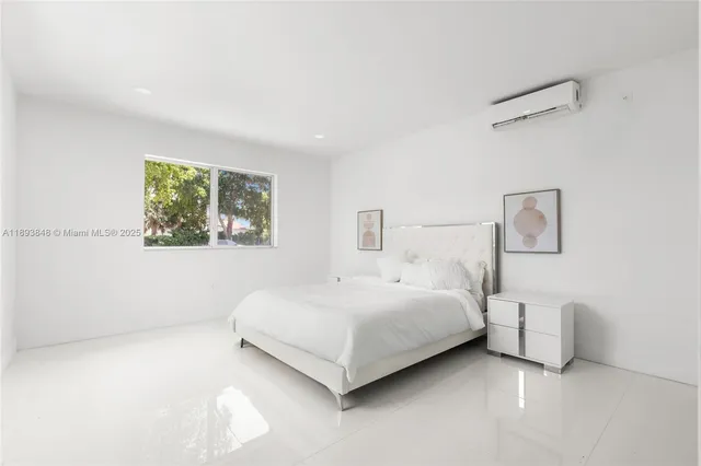 a bedroom with a bed lamp and on the wall