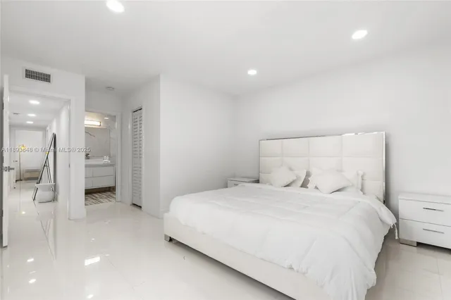 a bedroom with a bed and a walk in closet