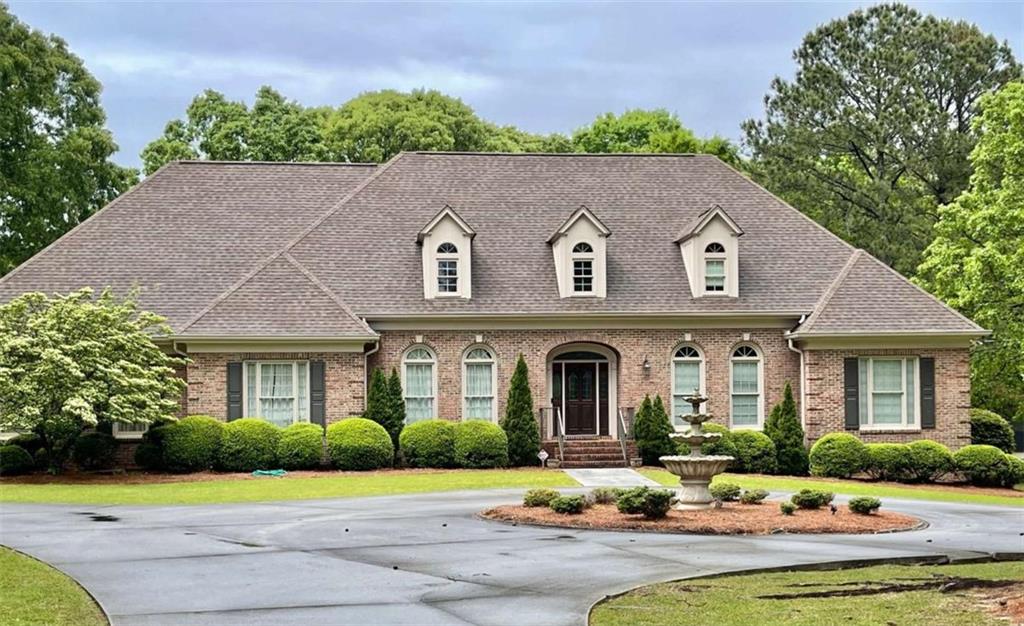 1551 Pharrs Road Snellville, GA 30078 - Photo 1 of 1 a front view of a house with garden and porch