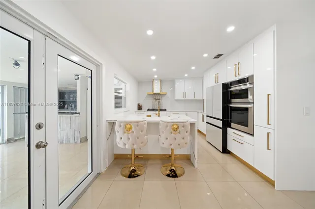 a kitchen with stainless steel appliances granite countertop a refrigerator and a sink