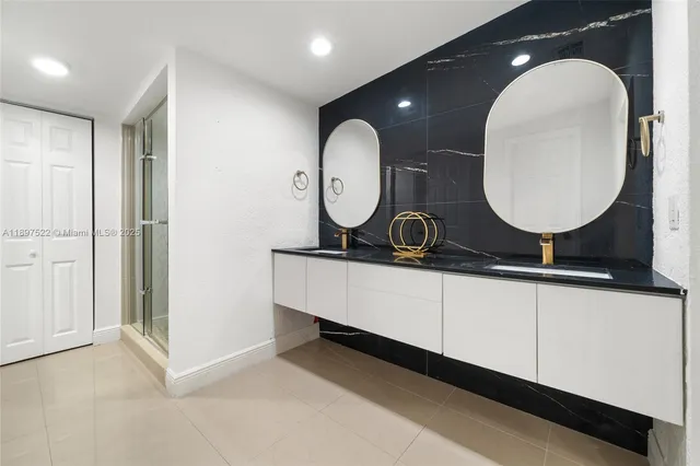 a bathroom with a double vanity sink and a mirror