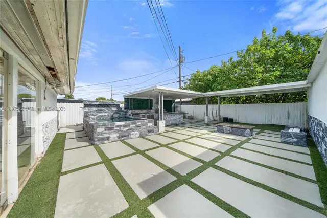 a view of a house with backyard sitting area