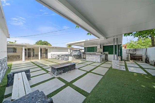 a view of a patio with table and chairs with wooden floor and fence
