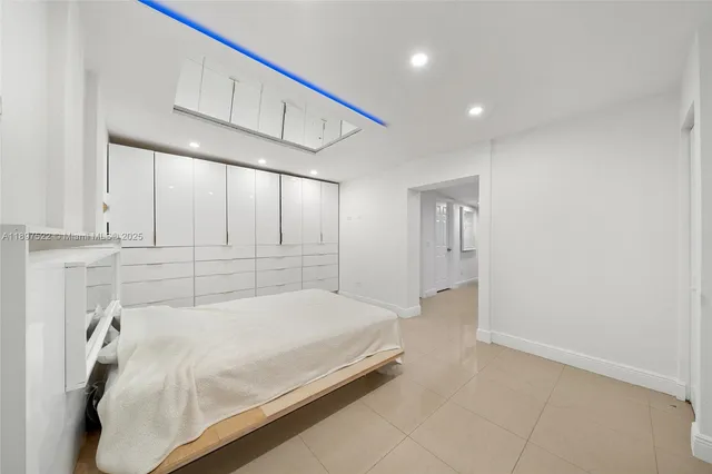 a spacious bedroom with a bed and a window