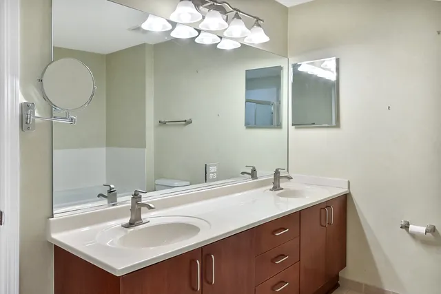 a bathroom with a sink vanity and a mirror