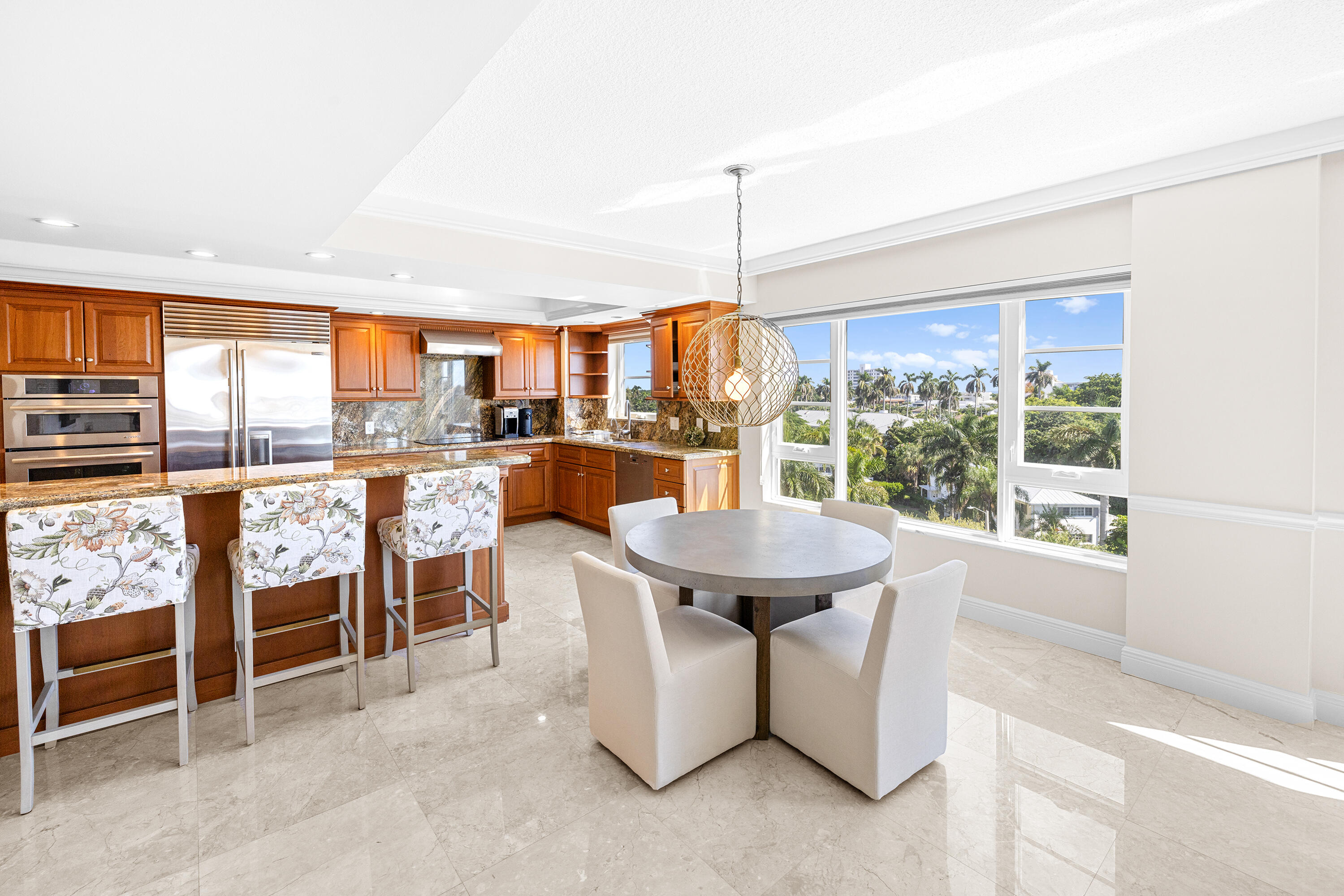 50 E Road, Unit 6E Delray Beach, FL 33483 - Photo 11 of 36 a dining room with furniture a chandelier and a floor to ceiling window