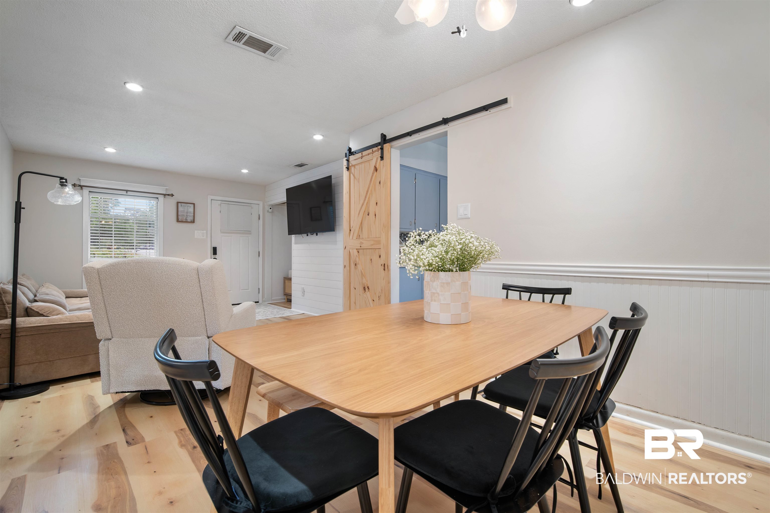 1451 West Morlee Drive Mobile, AL 36618 - Photo 11 of 30 Dining space with a barn door, recessed lighting, a wainscoted wall, and light LVP flooring