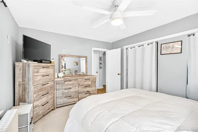 a bedroom with a bed and a flat screen tv in it