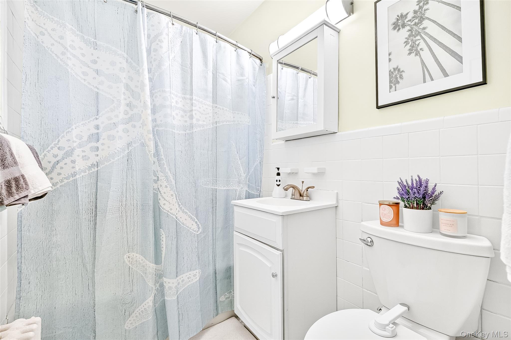 340 Richbell Road, Unit B4 Mamaroneck, NY 10543 - Photo 19 of 24 a bathroom with a sink a toilet and a mirror
