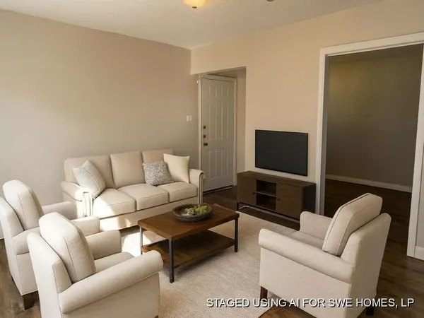 a living room with furniture and a flat screen tv