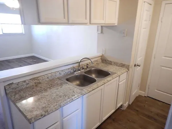 a kitchen with a sink and cabinets