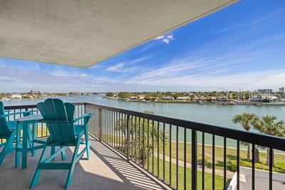 9425 Blind Pass Road, Unit 408 St. Pete Beach, FL 33706 - Photo 1 of 57 a city view from a balcony