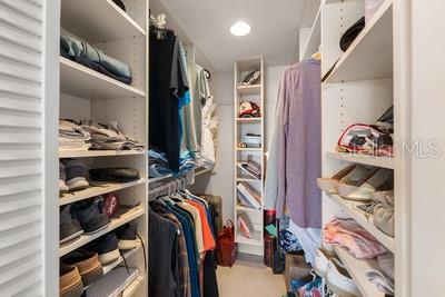9425 Blind Pass Road, Unit 408 St. Pete Beach, FL 33706 - Photo 14 of 57 a view of walk in closet with clothes and shoes