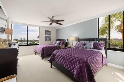 9425 Blind Pass Road, Unit 408 St. Pete Beach, FL 33706 - Photo 15 of 57 a spacious bedroom with two beds and large windows