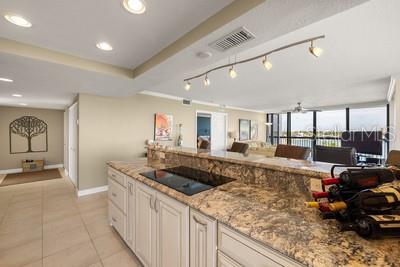 9425 Blind Pass Road, Unit 408 St. Pete Beach, FL 33706 - Photo 18 of 57 a large white kitchen with a large window