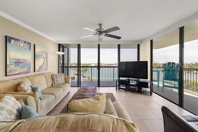 9425 Blind Pass Road, Unit 408 St. Pete Beach, FL 33706 - Photo 20 of 57 a living room with furniture and a flat screen tv