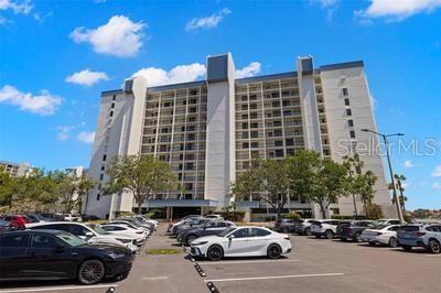 9425 Blind Pass Road, Unit 408 St. Pete Beach, FL 33706 - Photo 2 of 57 a city street lined with parked cars and buildings