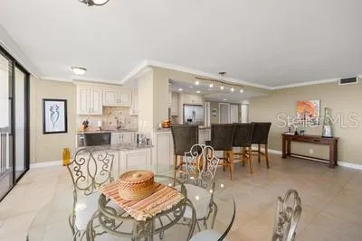 a living room with furniture and kitchen view