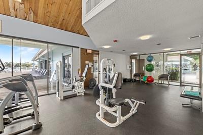9425 Blind Pass Road, Unit 408 St. Pete Beach, FL 33706 - Photo 29 of 57 a view of a room with gym equipment