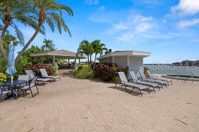 9425 Blind Pass Road, Unit 408 St. Pete Beach, FL 33706 - Photo 41 of 57 a view of a backyard with a sitting area and furniture