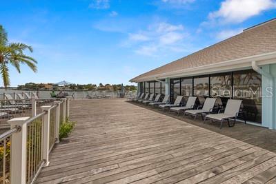 9425 Blind Pass Road, Unit 408 St. Pete Beach, FL 33706 - Photo 44 of 57 a balcony with wooden floor and city view
