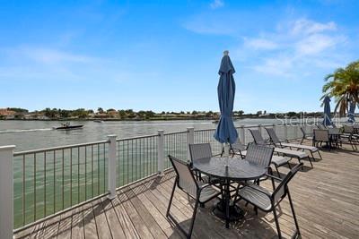 9425 Blind Pass Road, Unit 408 St. Pete Beach, FL 33706 - Photo 46 of 57 a view of a lake with couches and wooden floor