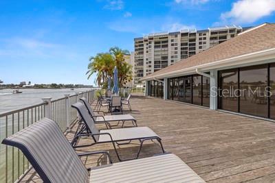 9425 Blind Pass Road, Unit 408 St. Pete Beach, FL 33706 - Photo 48 of 57 a terrace with outdoor seating and city view