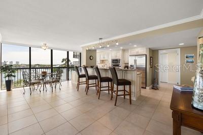 9425 Blind Pass Road, Unit 408 St. Pete Beach, FL 33706 - Photo 5 of 57 a dining hall with a dining table chairs and view of living room