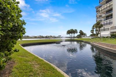 9425 Blind Pass Road, Unit 408 St. Pete Beach, FL 33706 - Photo 52 of 57 a view of a lake with a large building