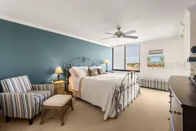 a spacious bedroom with a bed and a chandelier