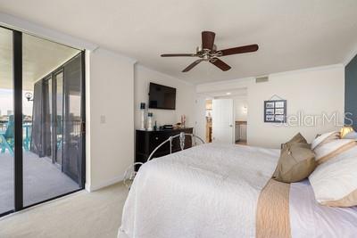 9425 Blind Pass Road, Unit 408 St. Pete Beach, FL 33706 - Photo 9 of 57 a bedroom with a bed and a mirror