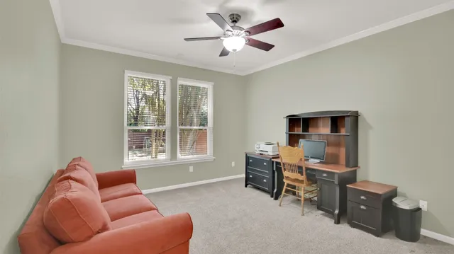 a livingroom with workspace and a window