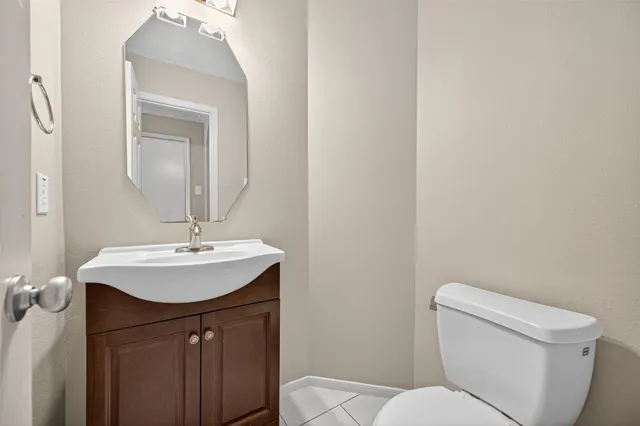 a bathroom with a toilet a sink and mirror