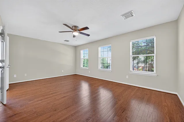 wooden floor in an empty room with a window