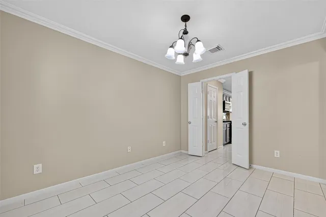 a view of an empty room with a chandelier