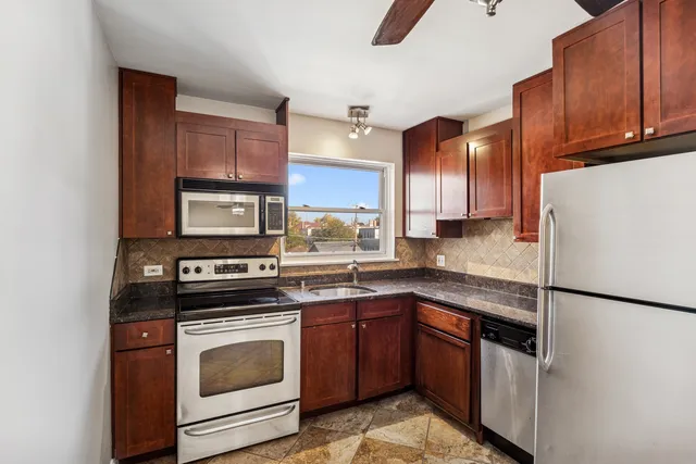 a kitchen with a stove top oven sink and refrigerator