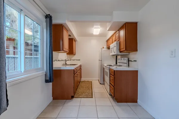 a kitchen with stainless steel appliances granite countertop a refrigerator and a stove
