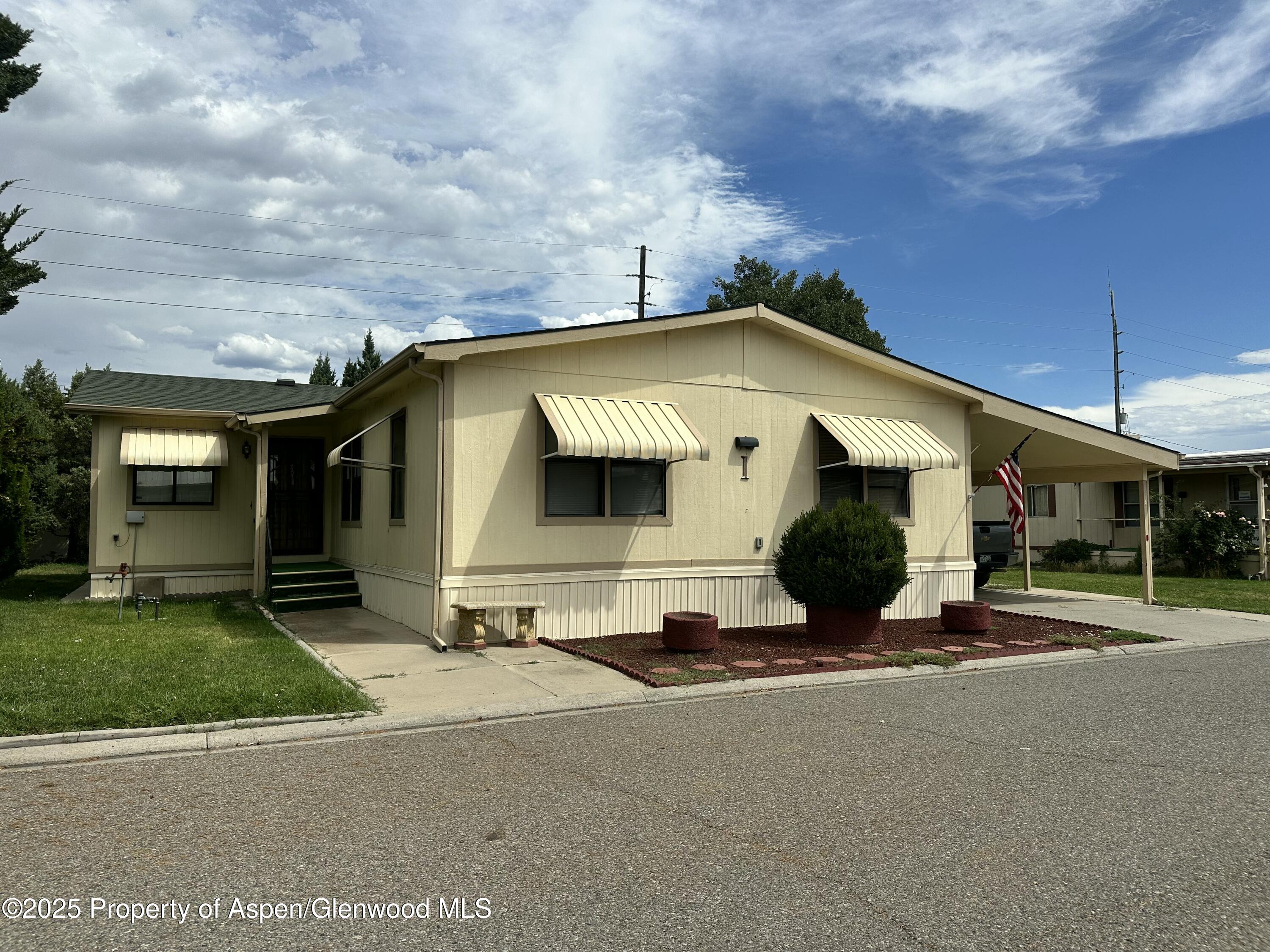 3195 F Road, Unit 1 Grand Junction, CO 81504 - Photo 2 of 22 a front view of a house with a yard