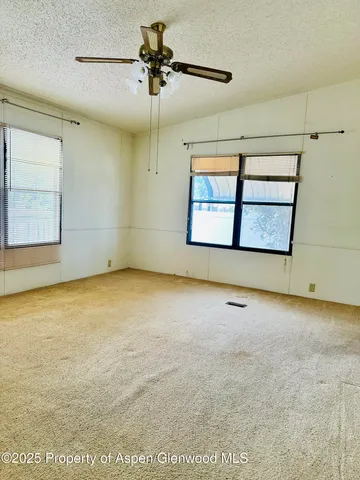a view of room with window and ceiling fan