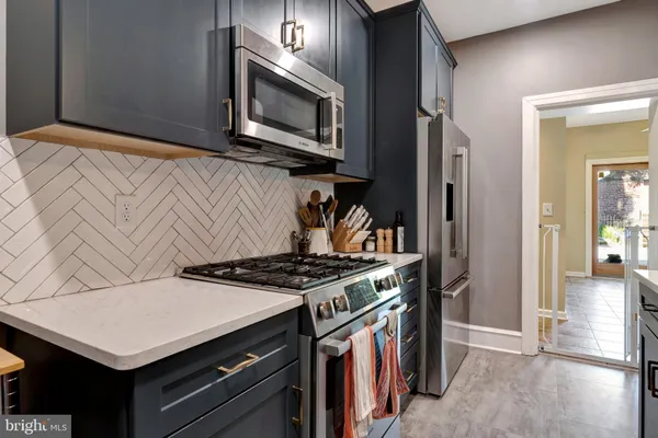 a kitchen with stainless steel appliances a stove a microwave and cabinets