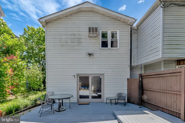 a front view of a house with outdoor seating